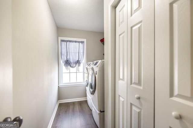 laundry area featuring dark hardwood / wood-style flooring, a textured ceiling, and independent washer and dryer