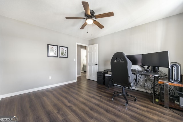 home office with ceiling fan and dark hardwood / wood-style flooring