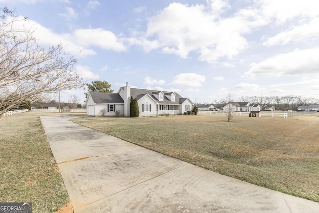 cape cod-style house featuring a front lawn