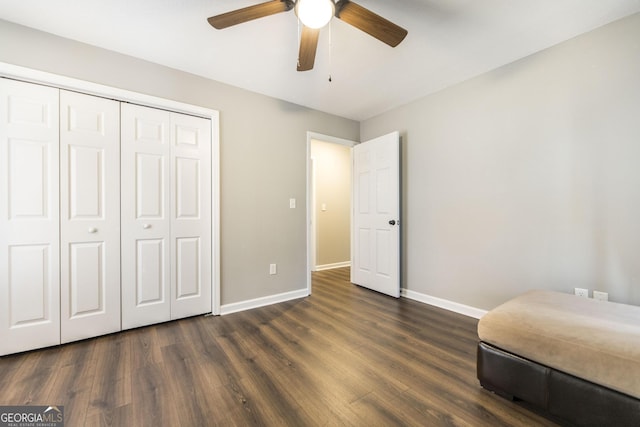 bedroom with ceiling fan, dark hardwood / wood-style flooring, and a closet