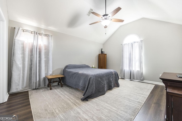 bedroom with ceiling fan, lofted ceiling, and dark hardwood / wood-style flooring