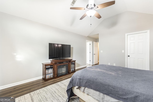 bedroom with ceiling fan, lofted ceiling, and dark hardwood / wood-style flooring