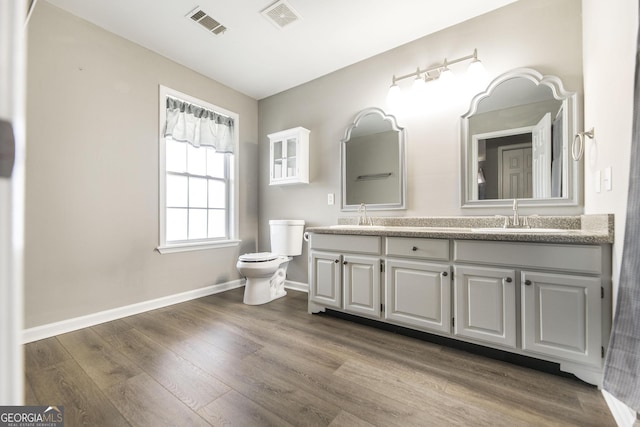 bathroom featuring vanity, hardwood / wood-style flooring, and toilet