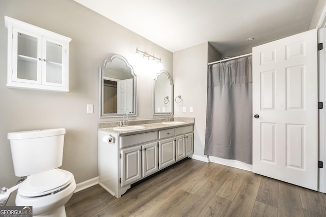 bathroom featuring vanity, hardwood / wood-style floors, toilet, and a shower with shower curtain