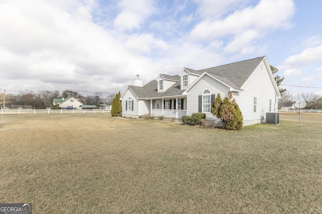 view of side of home with a lawn and central air condition unit