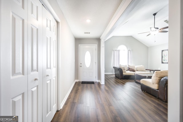 foyer featuring dark hardwood / wood-style flooring, lofted ceiling, and ceiling fan