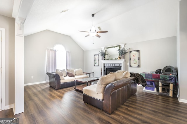 living room featuring a fireplace, decorative columns, lofted ceiling, ceiling fan, and dark wood-type flooring