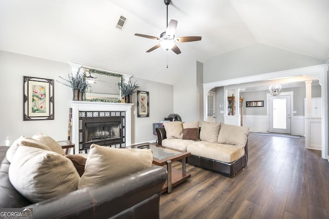 living room featuring ornate columns, a tile fireplace, vaulted ceiling, dark hardwood / wood-style flooring, and ceiling fan