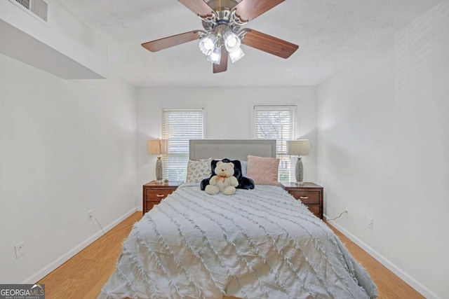 bedroom with ceiling fan and light wood-type flooring