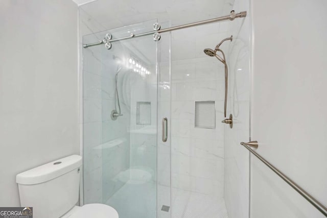 bathroom with toilet and walk in shower