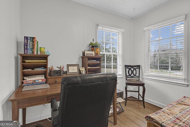 office with hardwood / wood-style flooring and plenty of natural light