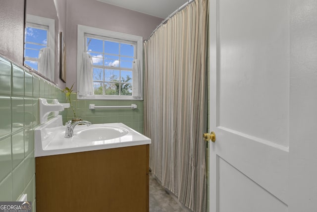 bathroom with tile walls and vanity