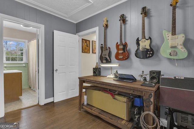 interior space featuring ornamental molding, dark hardwood / wood-style flooring, and a textured ceiling