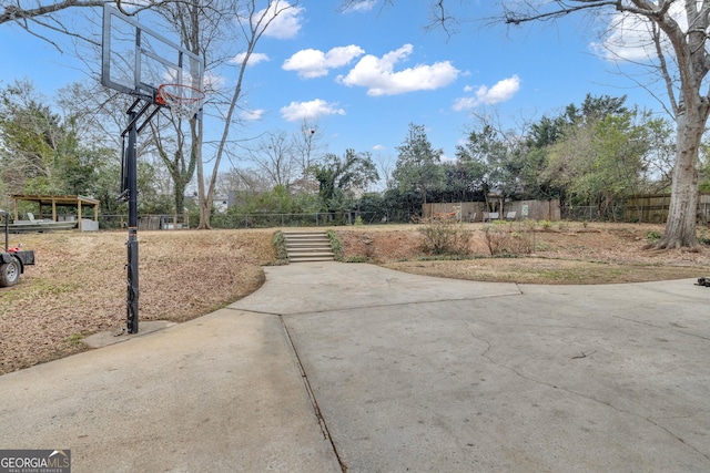 view of yard with basketball hoop