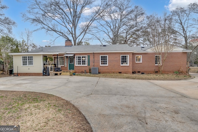 rear view of house with central AC unit