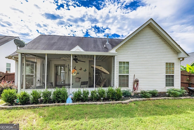 exterior space with ceiling fan, a sunroom, and a front yard