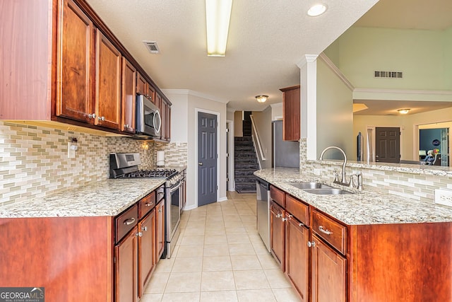 kitchen with sink, crown molding, stainless steel appliances, light stone countertops, and light tile patterned flooring