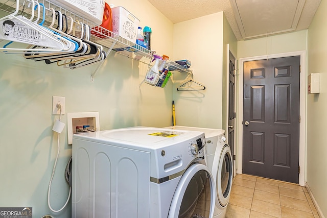 laundry area featuring separate washer and dryer and light tile patterned floors