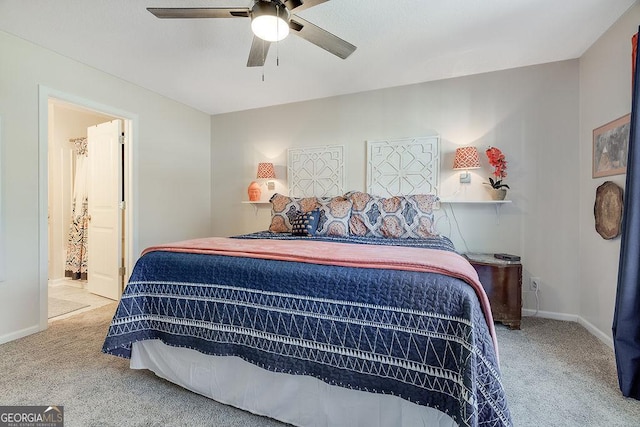 carpeted bedroom featuring ceiling fan and ensuite bath