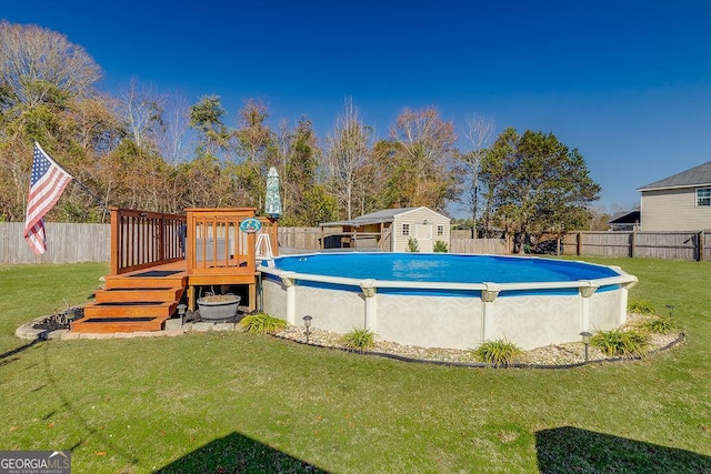 view of pool featuring a storage shed, a deck, and a lawn