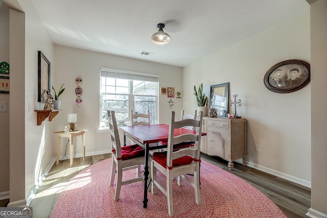 dining room with dark hardwood / wood-style flooring