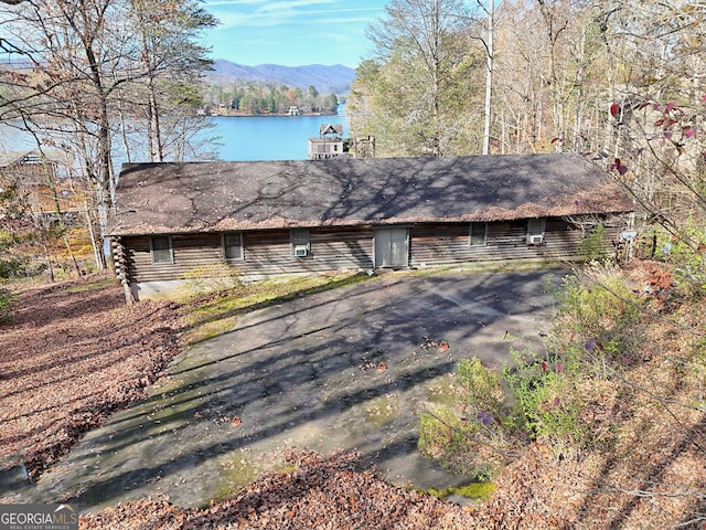 single story home with a water and mountain view