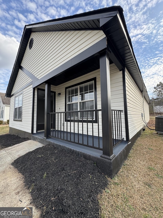 view of property exterior with central air condition unit and covered porch