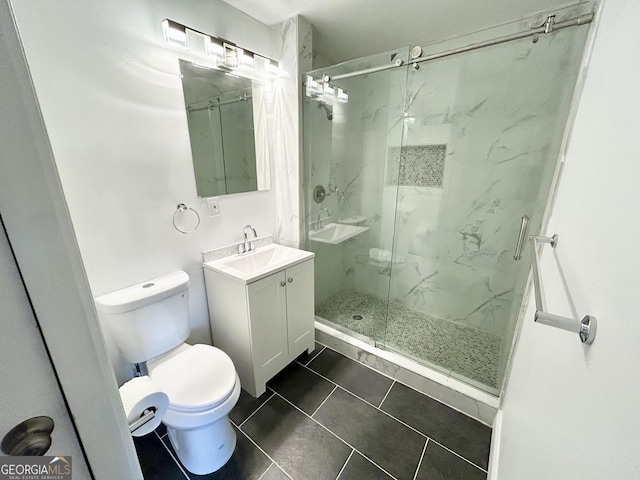 bathroom with vanity, tile patterned floors, toilet, and walk in shower