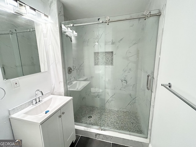 bathroom featuring vanity and an enclosed shower