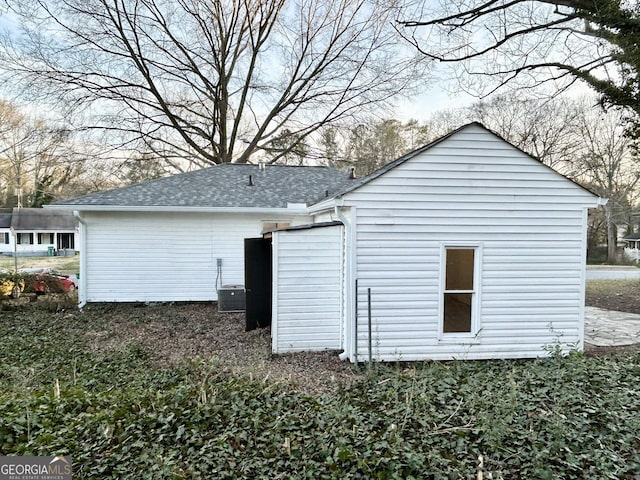 view of side of home featuring central AC