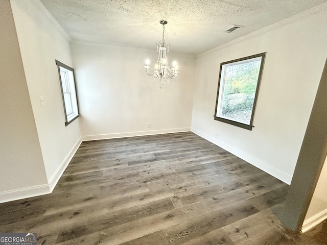 unfurnished dining area with crown molding, dark wood-type flooring, and a textured ceiling