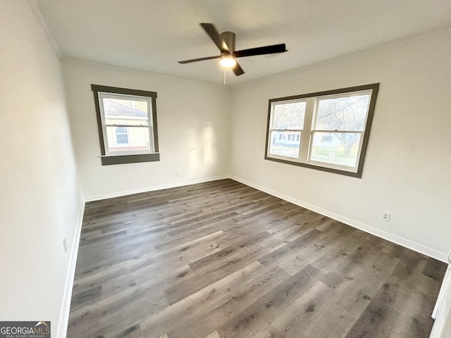 unfurnished room with dark wood-type flooring and ceiling fan