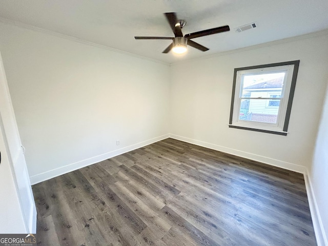 empty room with dark hardwood / wood-style flooring, crown molding, and ceiling fan