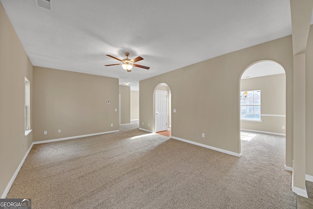 unfurnished room with light carpet, a textured ceiling, and ceiling fan