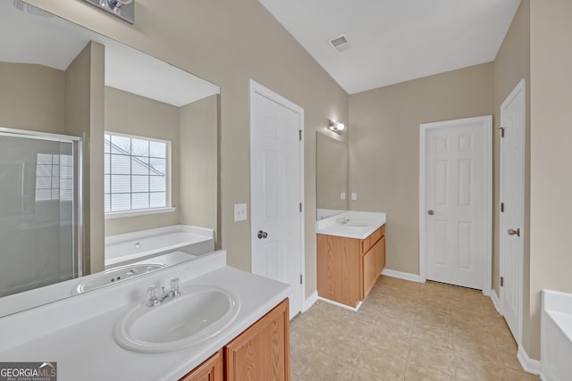 bathroom with vanity and independent shower and bath