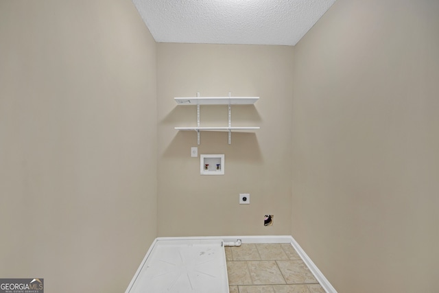 washroom with a textured ceiling, light tile patterned floors, electric dryer hookup, washer hookup, and hookup for a gas dryer