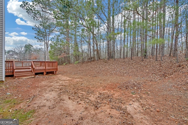 view of yard featuring a wooden deck