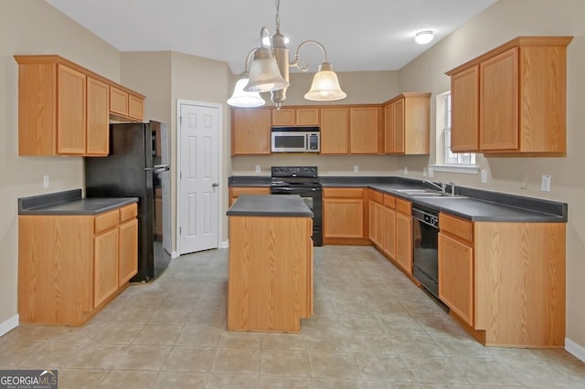 kitchen featuring light brown cabinetry, sink, hanging light fixtures, a kitchen island, and black appliances