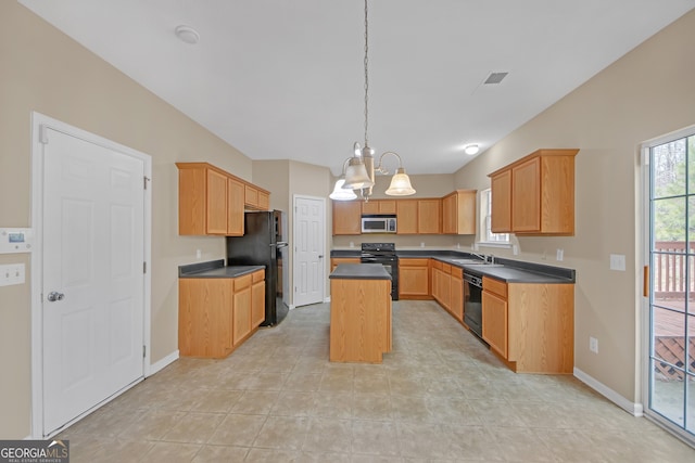 kitchen with pendant lighting, light brown cabinets, black appliances, and a kitchen island