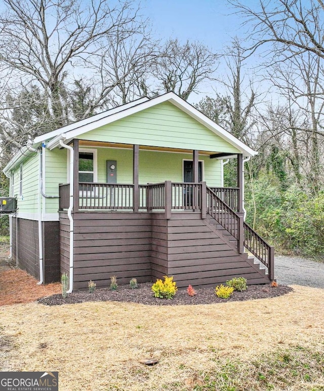 bungalow featuring central AC unit and covered porch