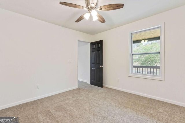 carpeted empty room featuring ceiling fan