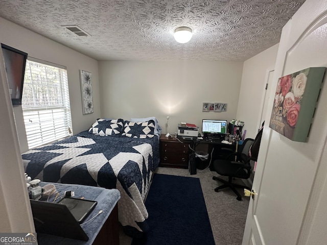 carpeted bedroom with a textured ceiling