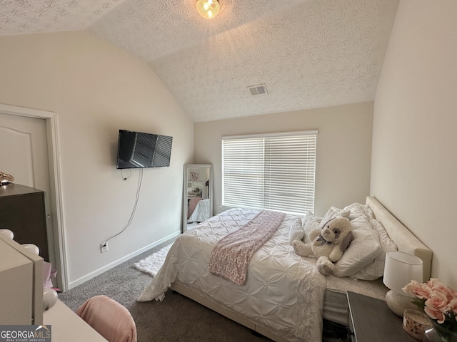 bedroom featuring vaulted ceiling, a textured ceiling, and dark colored carpet