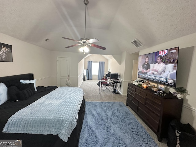 carpeted bedroom featuring vaulted ceiling, ceiling fan, and a textured ceiling