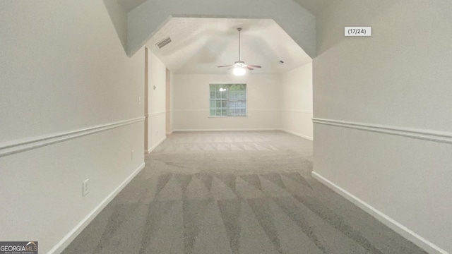 carpeted empty room featuring ceiling fan and vaulted ceiling