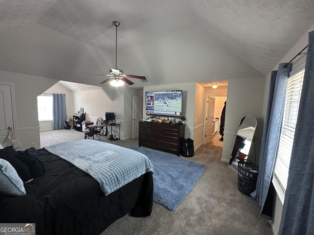 carpeted bedroom with ceiling fan, lofted ceiling, and a textured ceiling