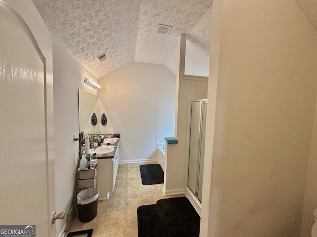 bathroom featuring vanity, a textured ceiling, lofted ceiling, and separate shower and tub