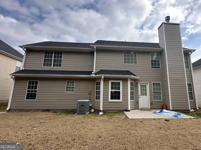 rear view of house with a yard, central AC unit, and a patio area