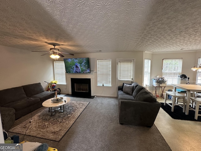 living room featuring a textured ceiling and ceiling fan