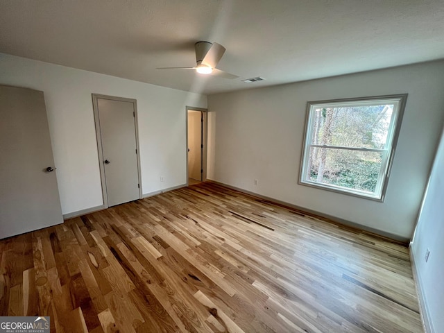 unfurnished bedroom with light hardwood / wood-style flooring and ceiling fan